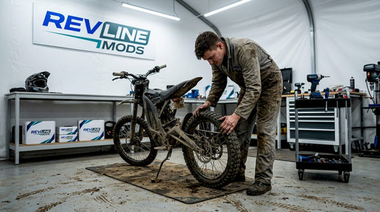 Mechanic tuning off-road bike in garage