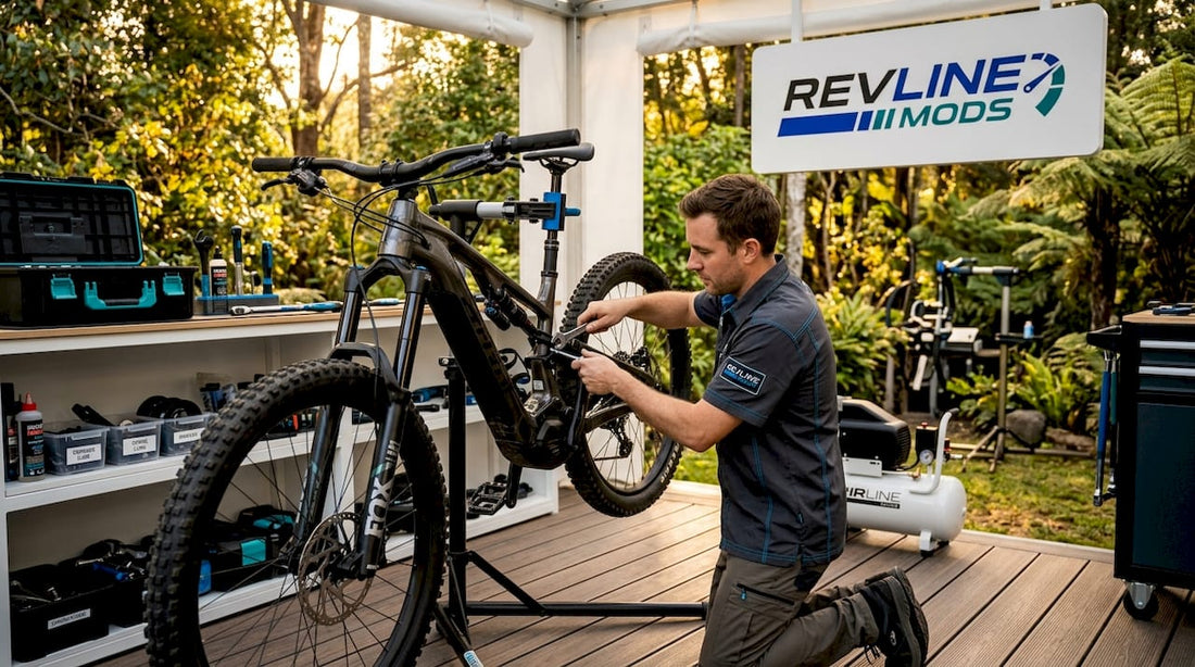 Man adjusts electric bike suspension in garage