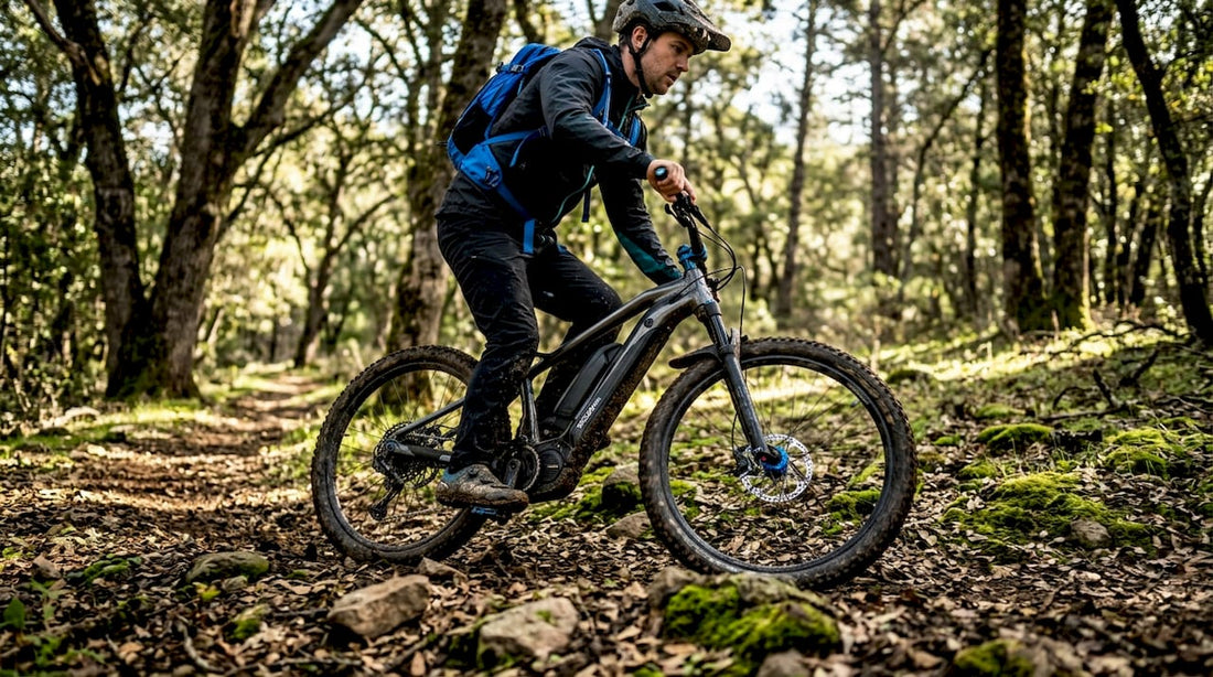Man riding off-road e-bike on forest trail