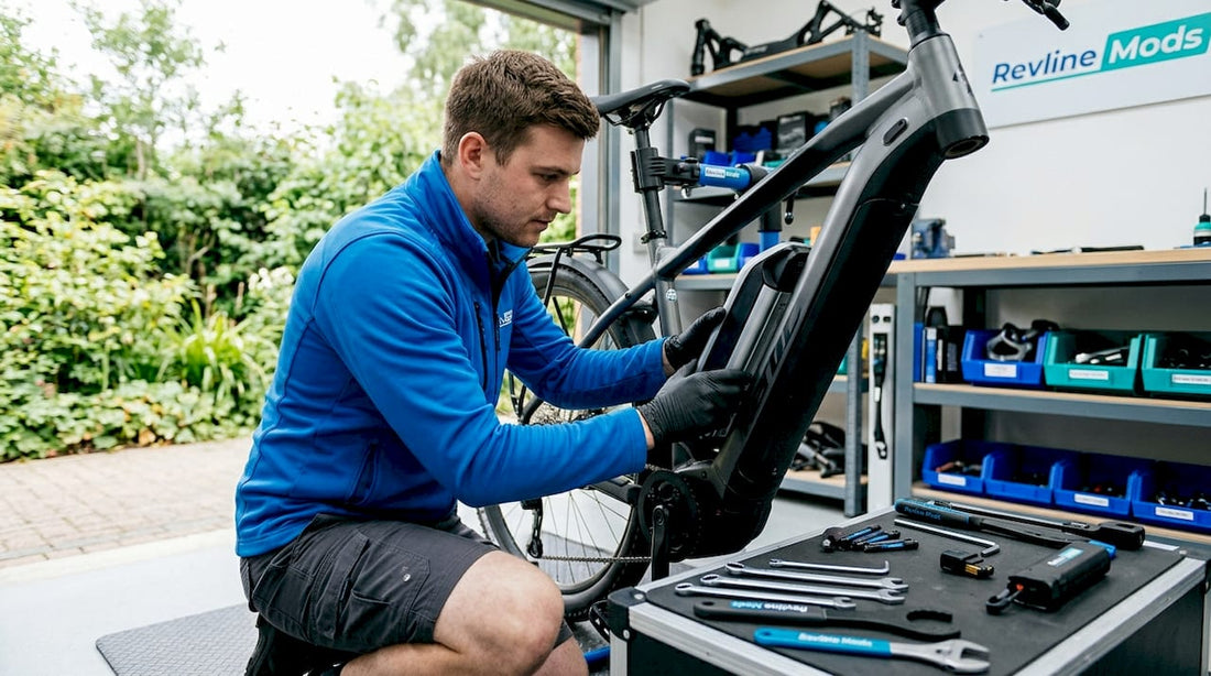 Technician installing lithium battery on e-bike